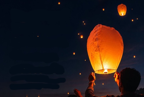 Balloons being launched into the night sky