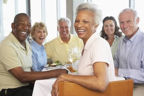 Older people sitting around a table